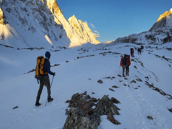 Trekkers crossing the snowy Larkya La Pass during the Manaslu Circuit Trek with panoramic Himalayan mountain views | Thrill Himalaya Treks