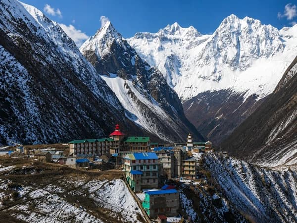 Samagaon village teahouses surrounded by snow-covered Himalayan peaks on the 14-day Manaslu Circuit Trek itinerary in Nepal with Thrill Himalaya Treks.