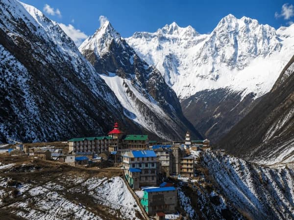 Samagaon village teahouses surrounded by snow-covered Himalayan peaks on the 14-day Manaslu Circuit Trek itinerary in Nepal with Thrill Himalaya Treks.