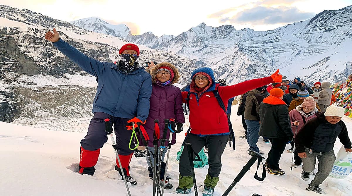 Family and children posing in snow at Annapurna Base Camp Nepal